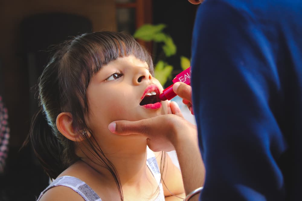 Girl having makeup applied